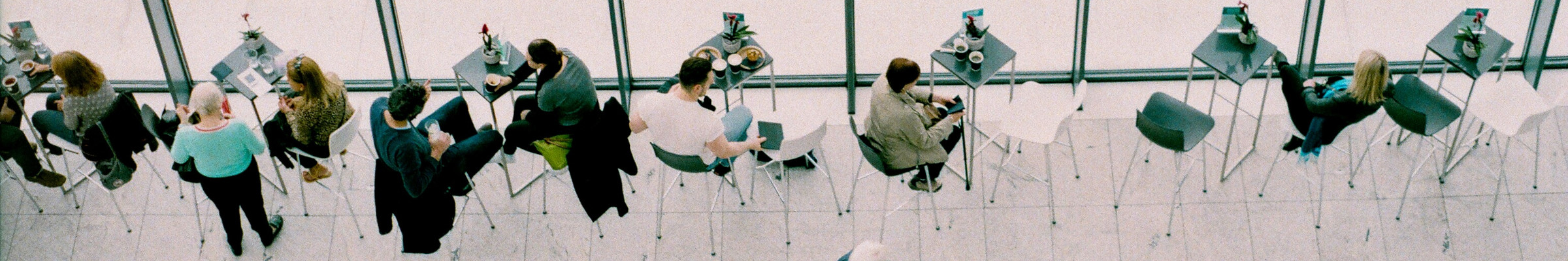 people sitting at tables seen from above