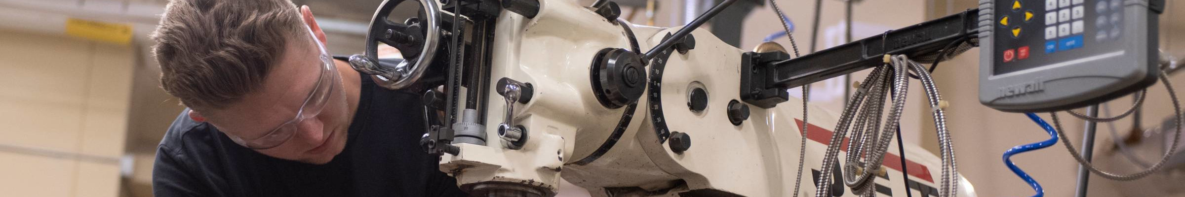 Photo of man with CNC machine.